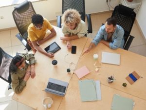 Small business marketing plan 6 simple steps - photo of four people working together taken from birds eye view