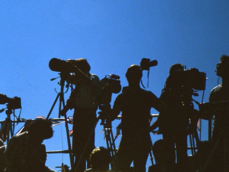 How to write a media release - photo of a group of photographers in front of a blue sky