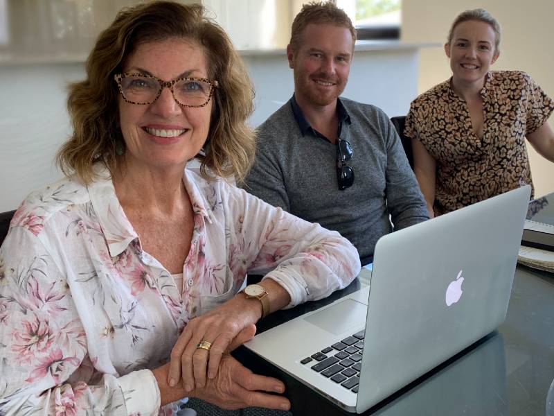 Liz sits with two small business coach clients