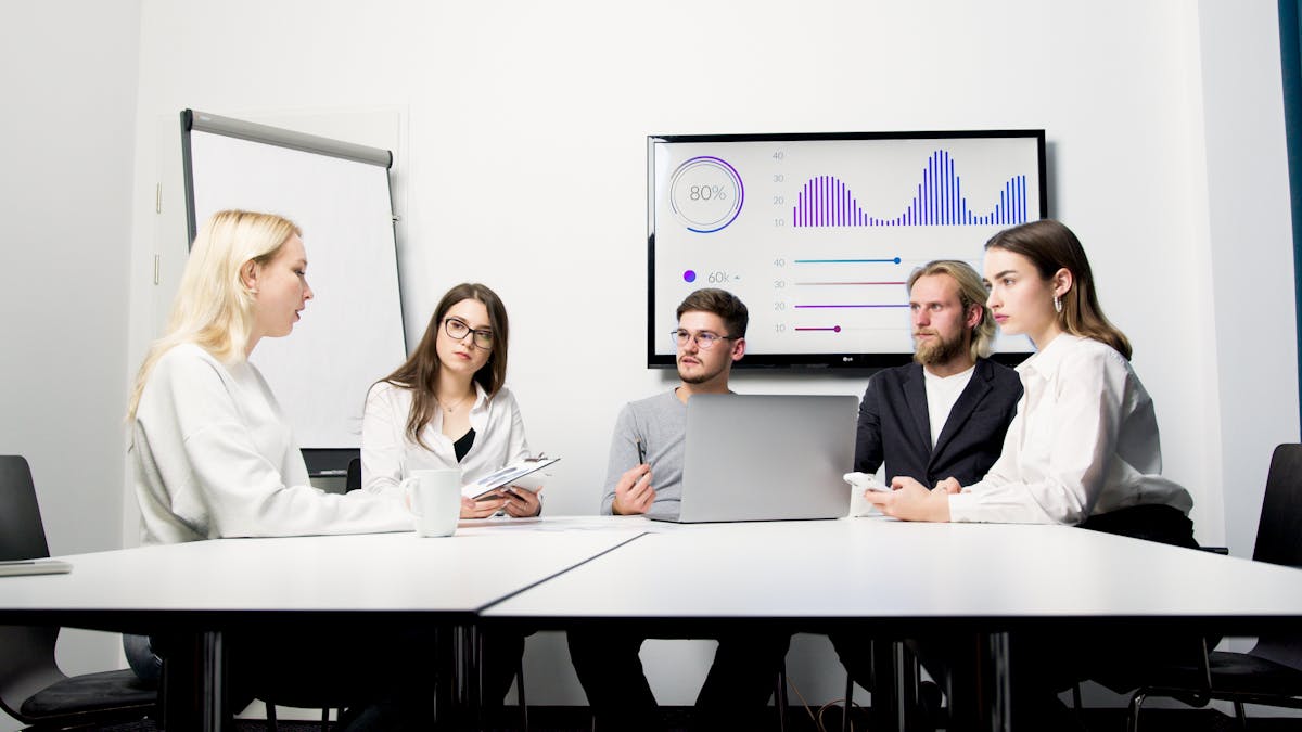Group of professionals reviewing a data presentation