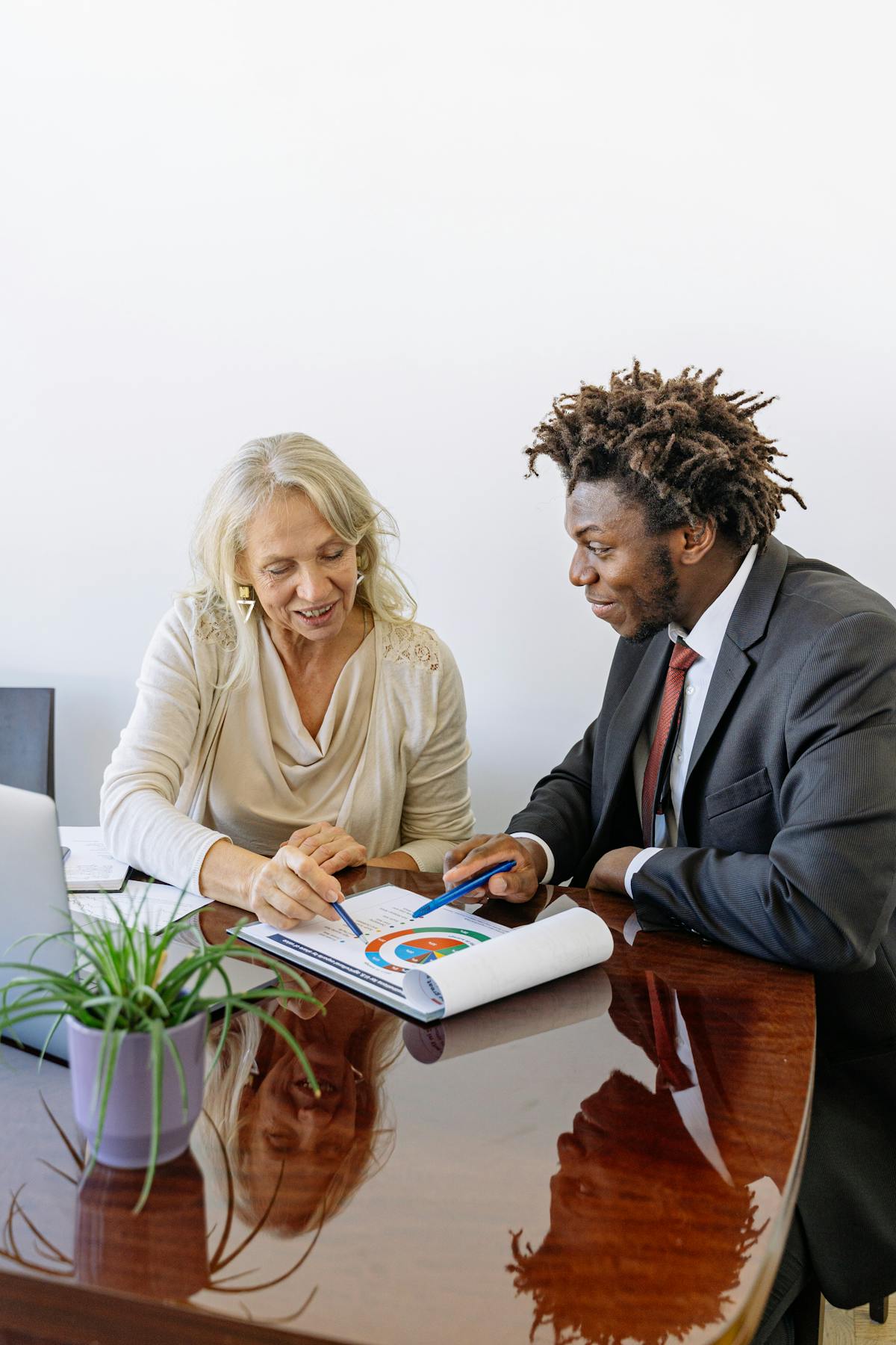 Two professionals discussing a business graph during a meeting